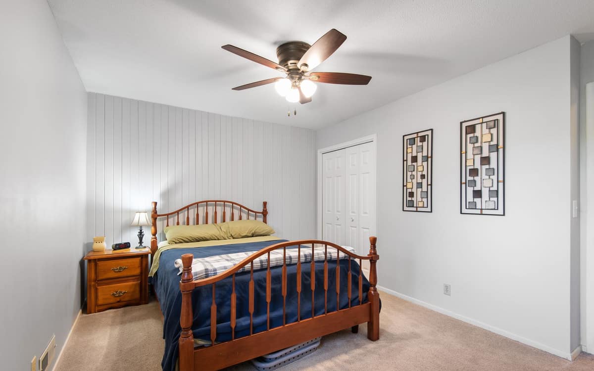 A compact fan on a bedroom nightstand