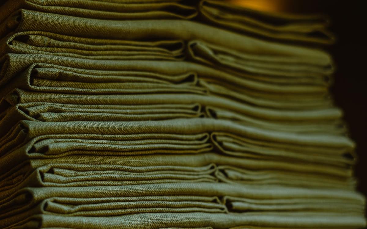 A stack of freshly laundered folded blankets