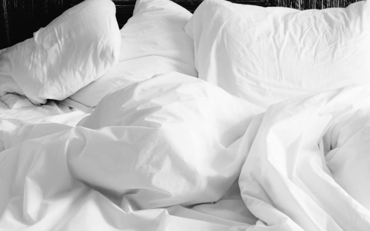A fitted sheet stretched over a deep mattress corner