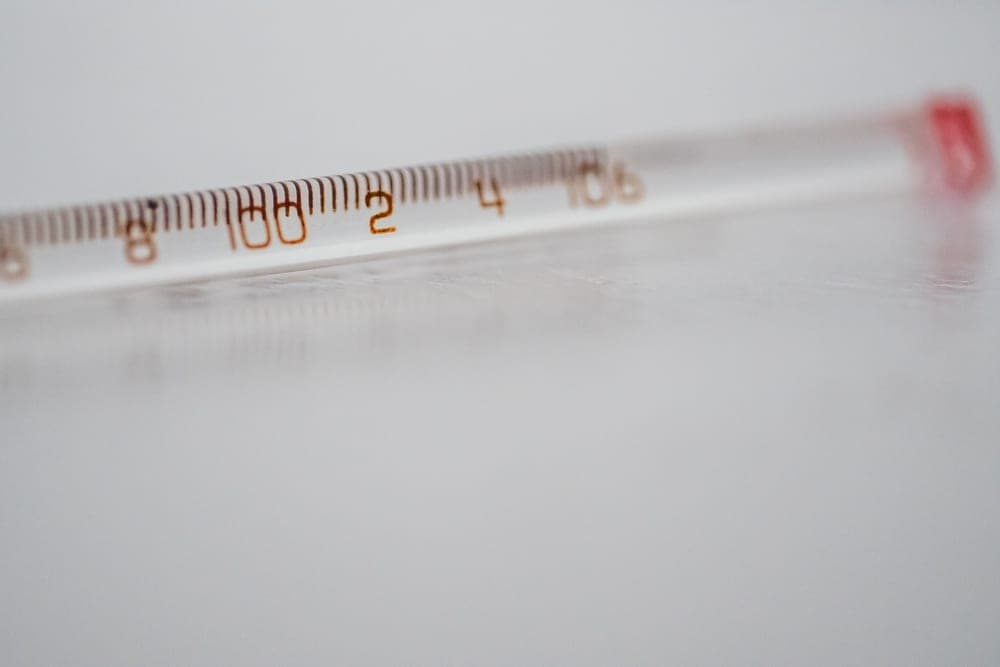 A thermometer resting on a light surface