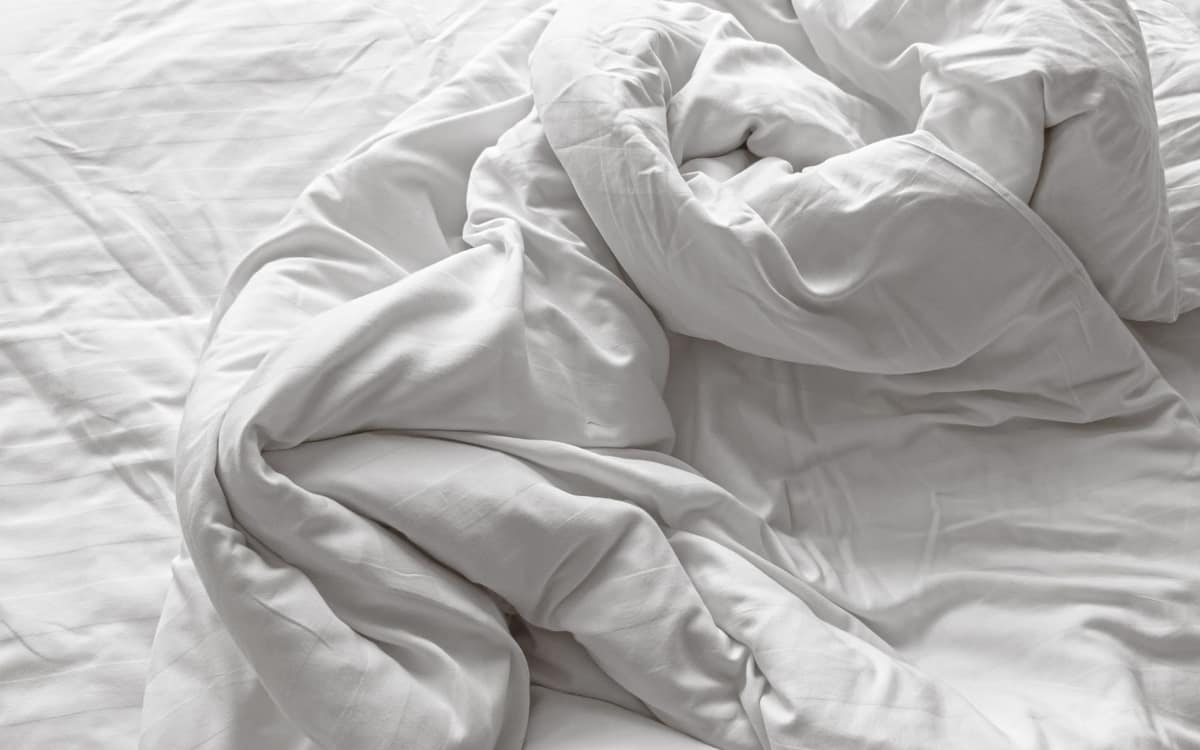 A fluffy white duvet insert on a bed