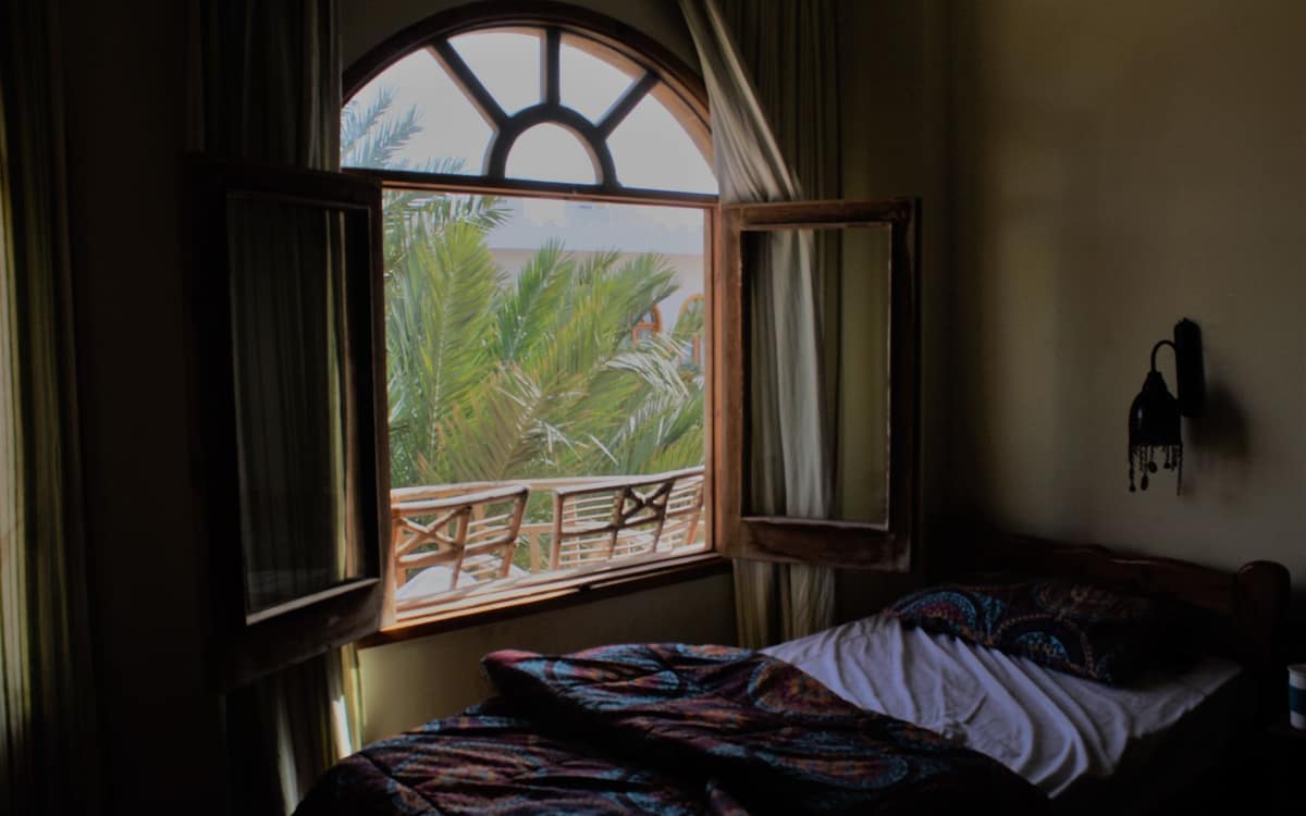 An open bedroom window on a humid summer night