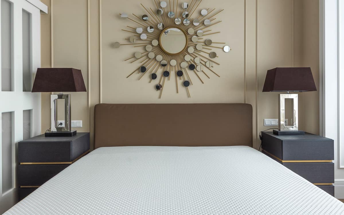 A cooling topper being layered onto a mattress