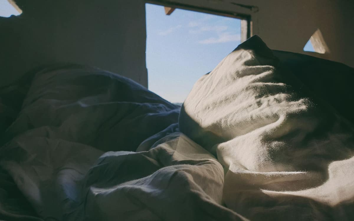 Rumpled bed sheets in the morning light