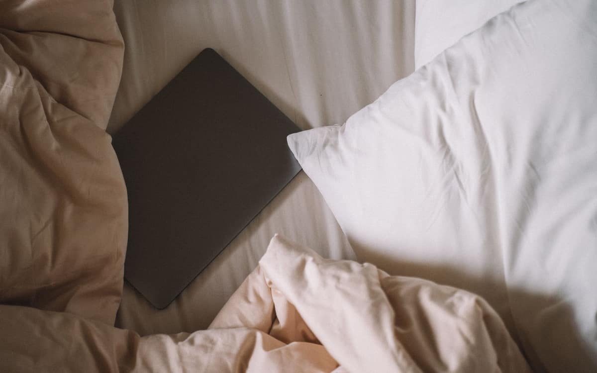 A thin, low-profile pillow on a made bed