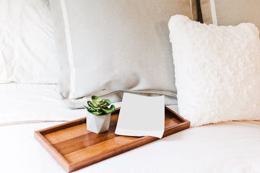 A pillow on a white bed, seen close up
