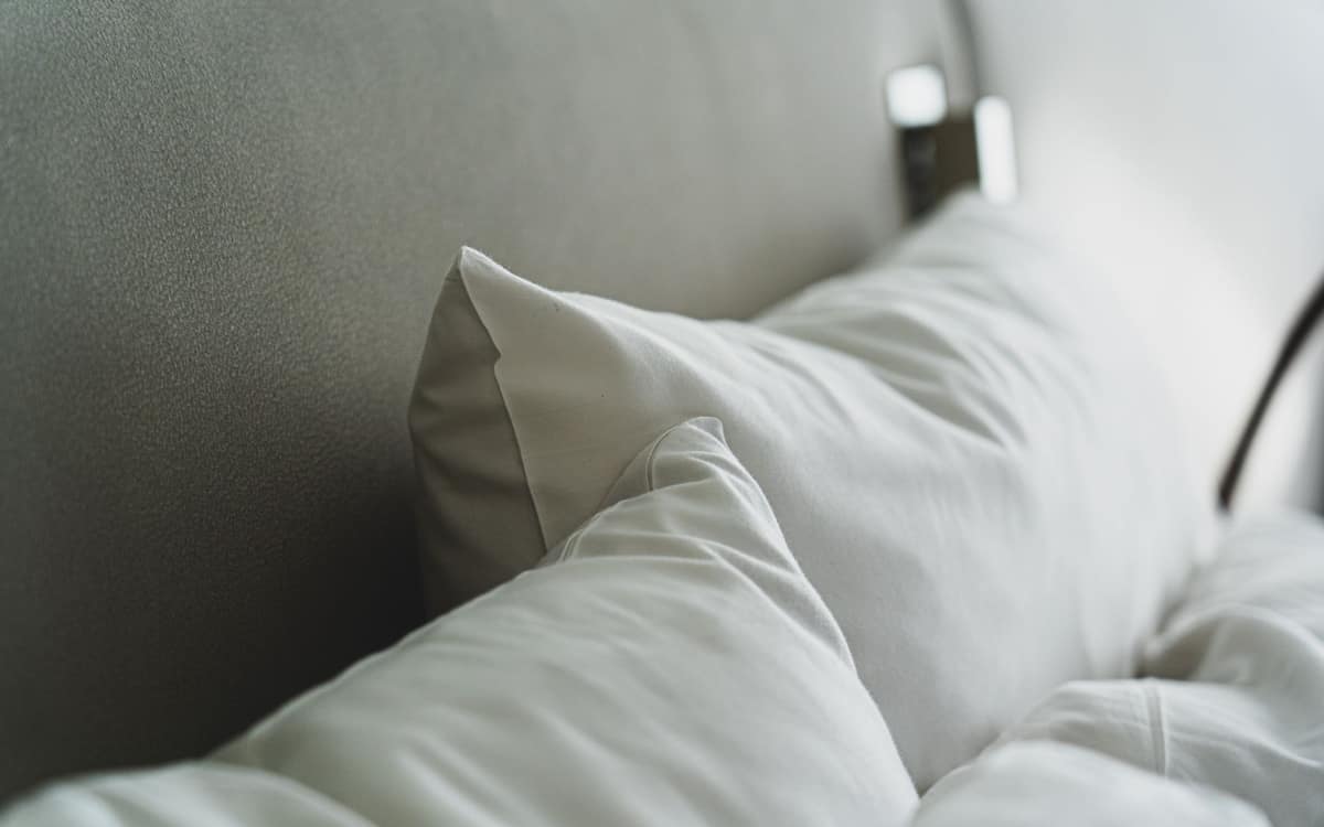 Close-up of white pillows and bedding on a neatly made bed