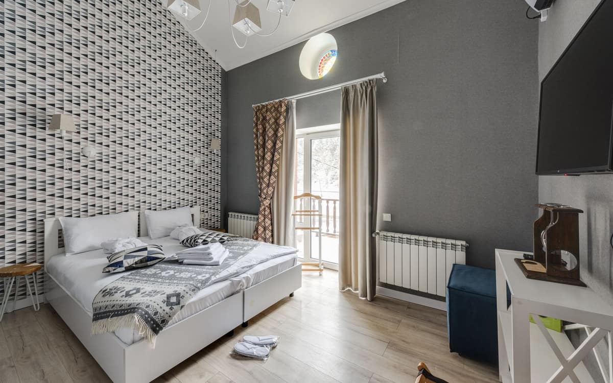 A bedroom radiator beneath a window on a winter night