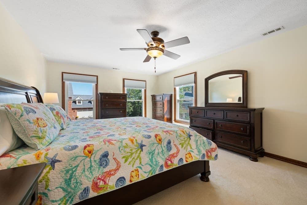A bright summer bedroom with light bedding
