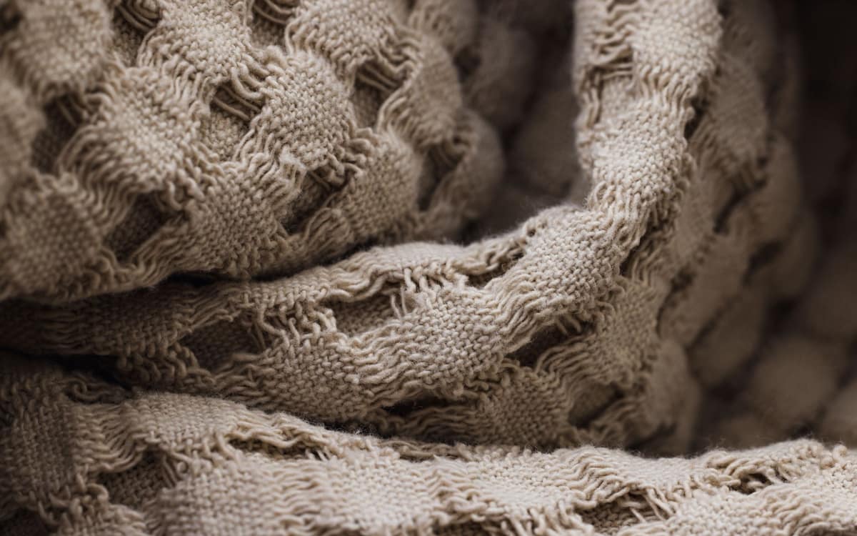 A folded waffle-weave blanket showing its texture