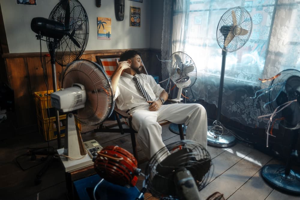 An electric fan standing in a sunlit room